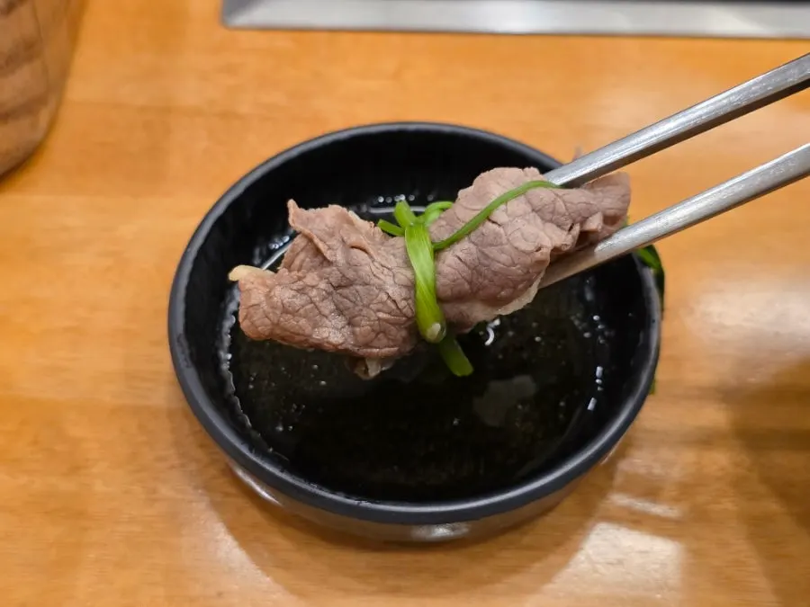 Pot of shabu with vegetables and beef added