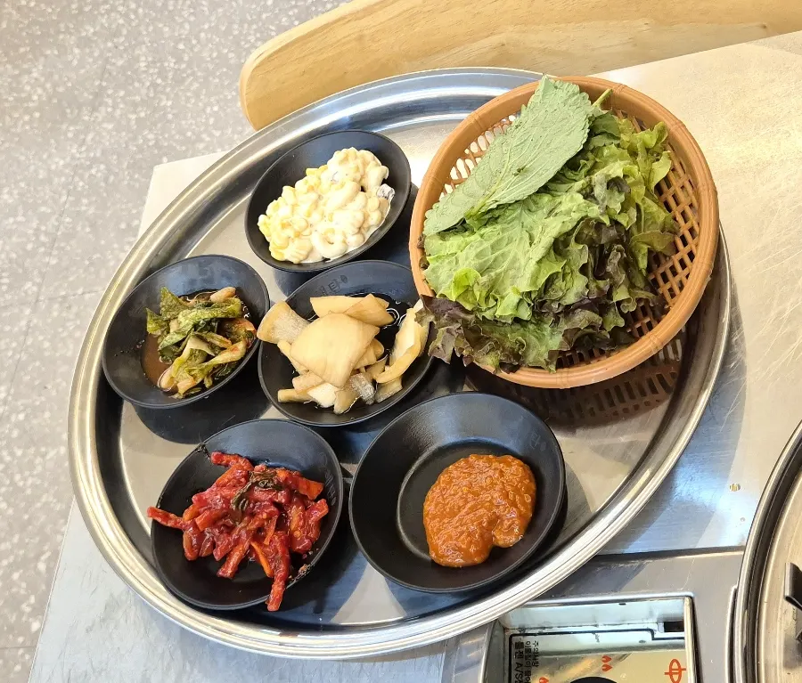 A tray full of side dishes set out on the table
