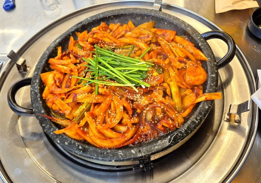 A plate of squid stir-fry in red sauce