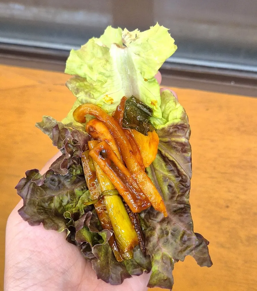 A wrap of squid stir-fry with lettuce