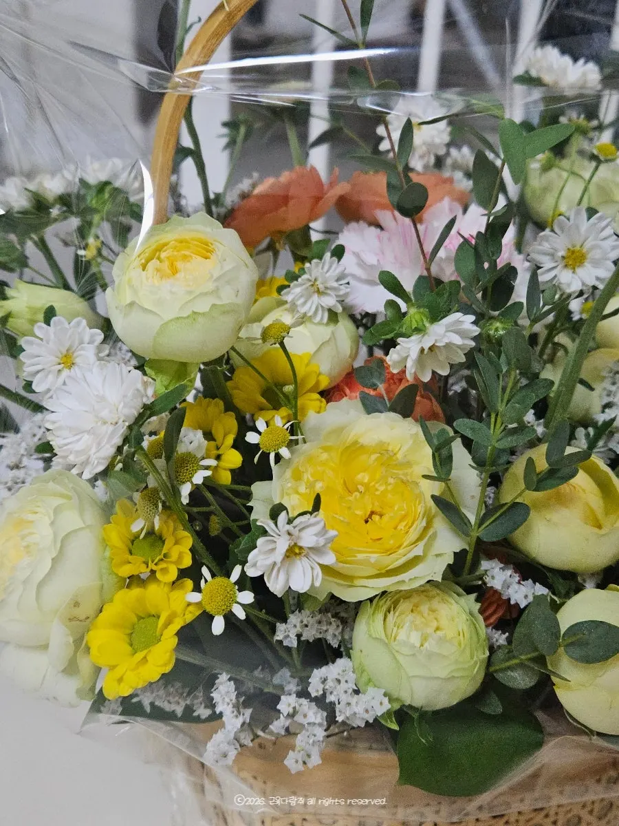 Flower basket accented with a yellow ribbon