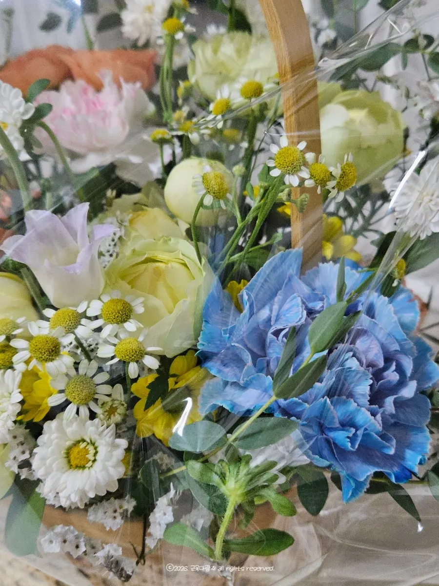 Side view of the basket filled with thick, fresh flowers