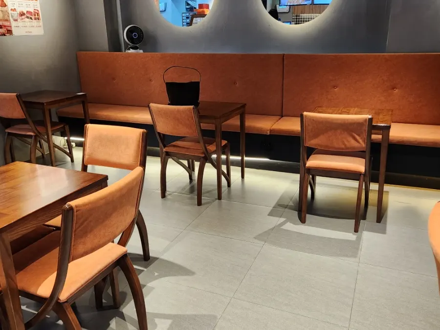 Tables and seats inside the calm-toned interior