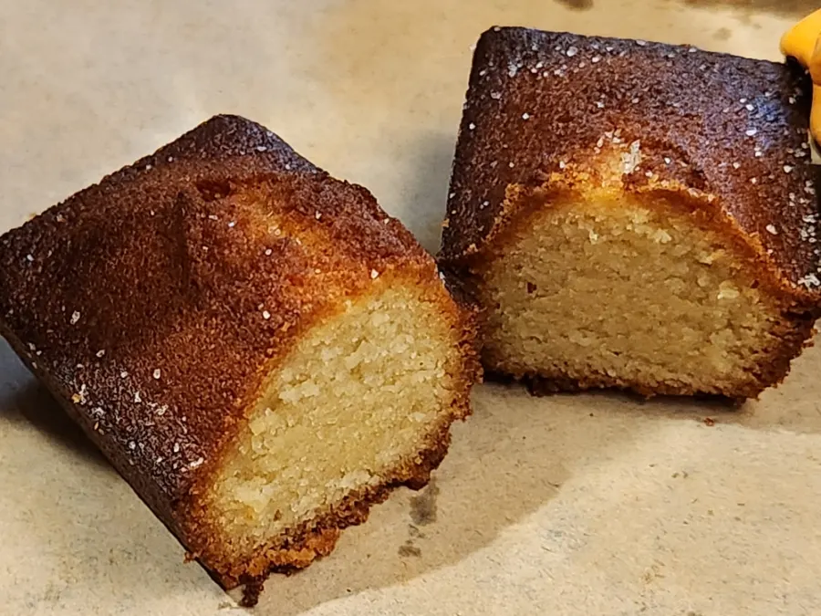 Cross-section of a financier showing its crisp-outside, chewy-inside texture