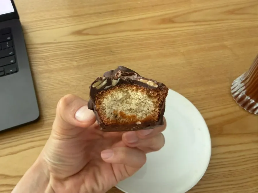 Cross-section of the financier topped with nuts and chocolate