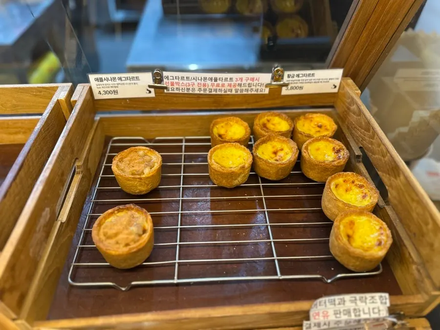 Display of financiers including salty, almond chocolate, and egg cheese