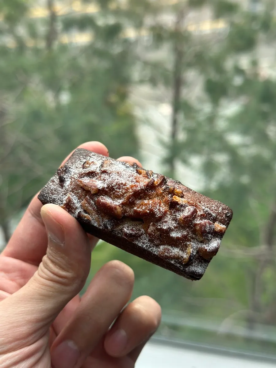 Cross-section of pecan pie financier with pecan topping