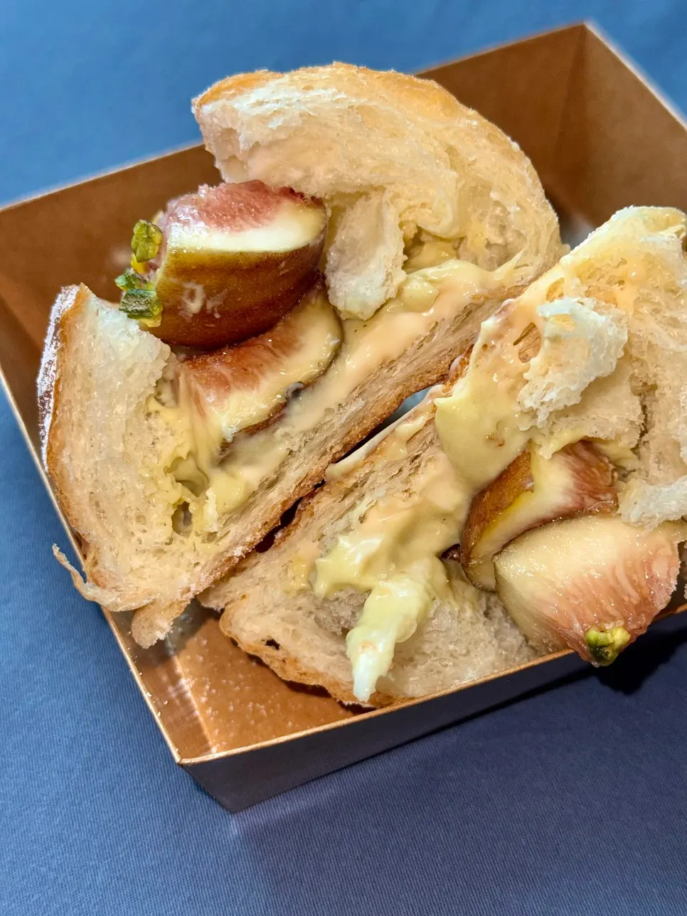Cross-section of salt bread showing fresh fig and pistachio cream