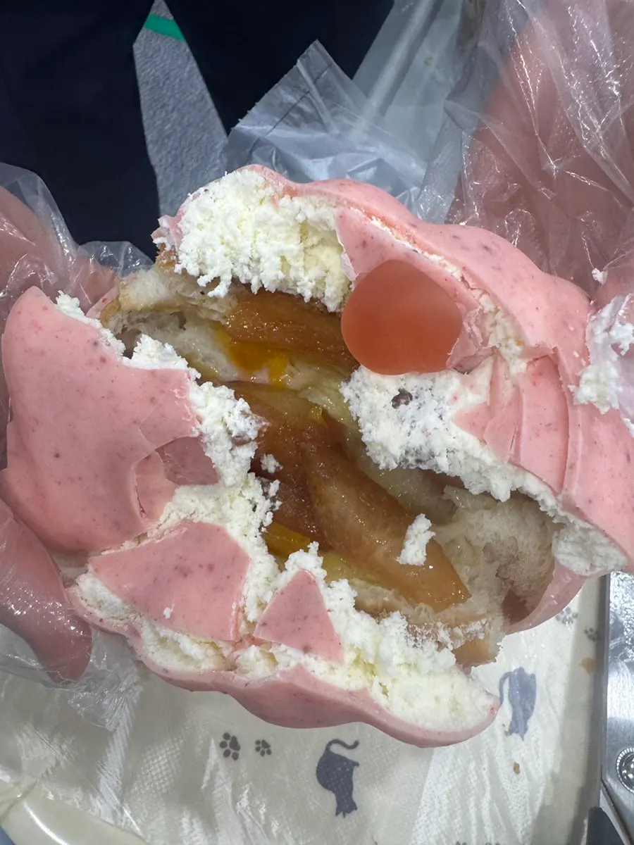 Cracking open the wakppu salt bread with plastic gloves