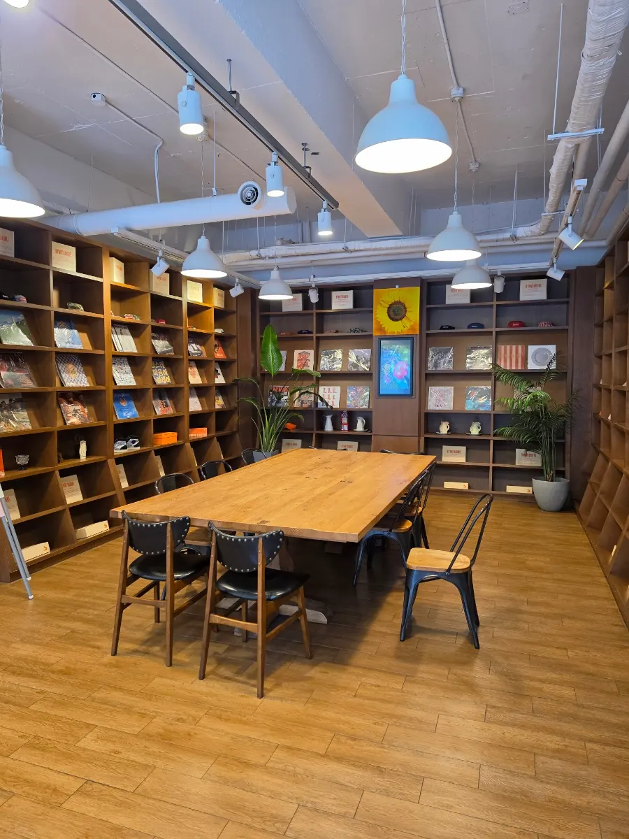 Large group table and bookshelf nook toward the back
