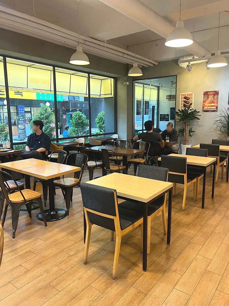 Study café seating with a long wooden table in front of a bookshelf