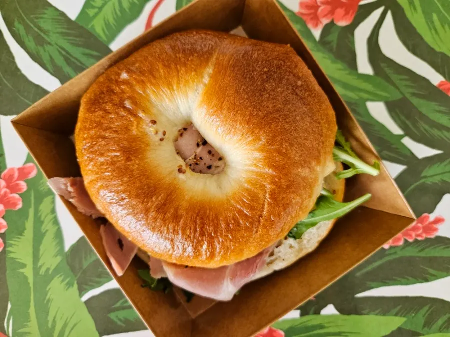 Cross section of jambon bagel with arugula