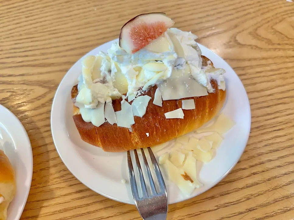 Cross-section of salt bread with fig and basque cheesecake inside
