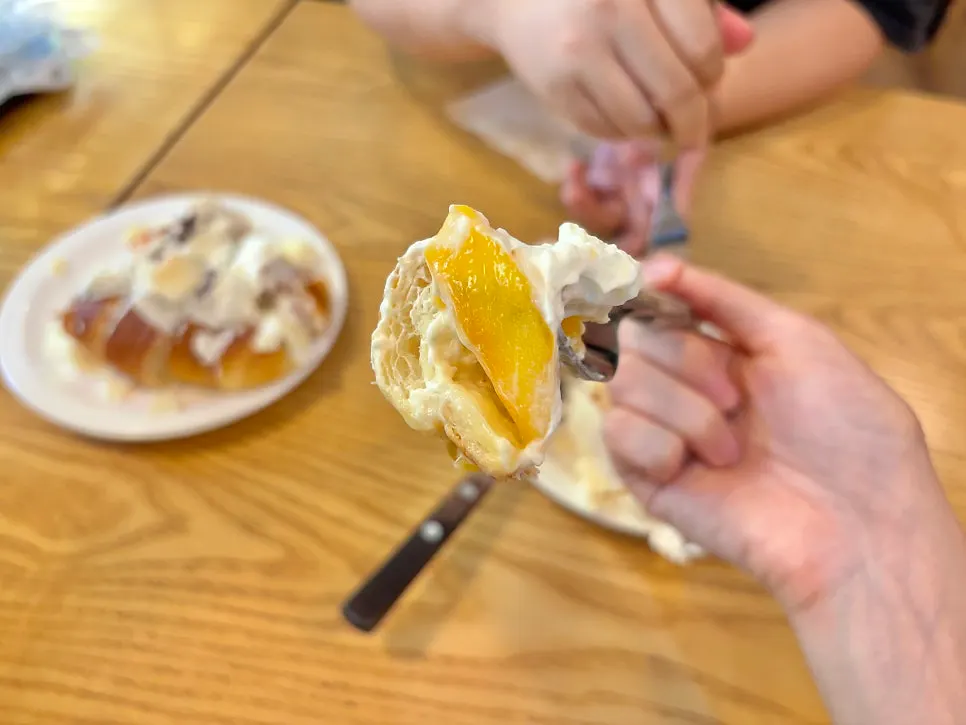 Cross-section of salt bread with fresh peach and yogurt cream inside