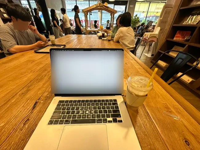 Salt bread and latte placed beside a laptop