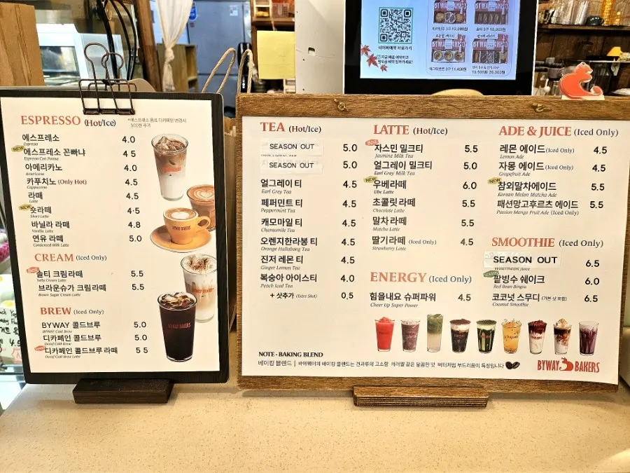 Drink menu board listing coffee and lattes