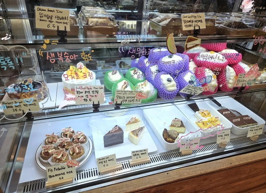 Fridge case with whole cakes and slice cakes
