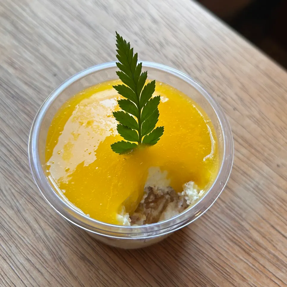 Cross-section of apple mango cheesecake cut with a fork