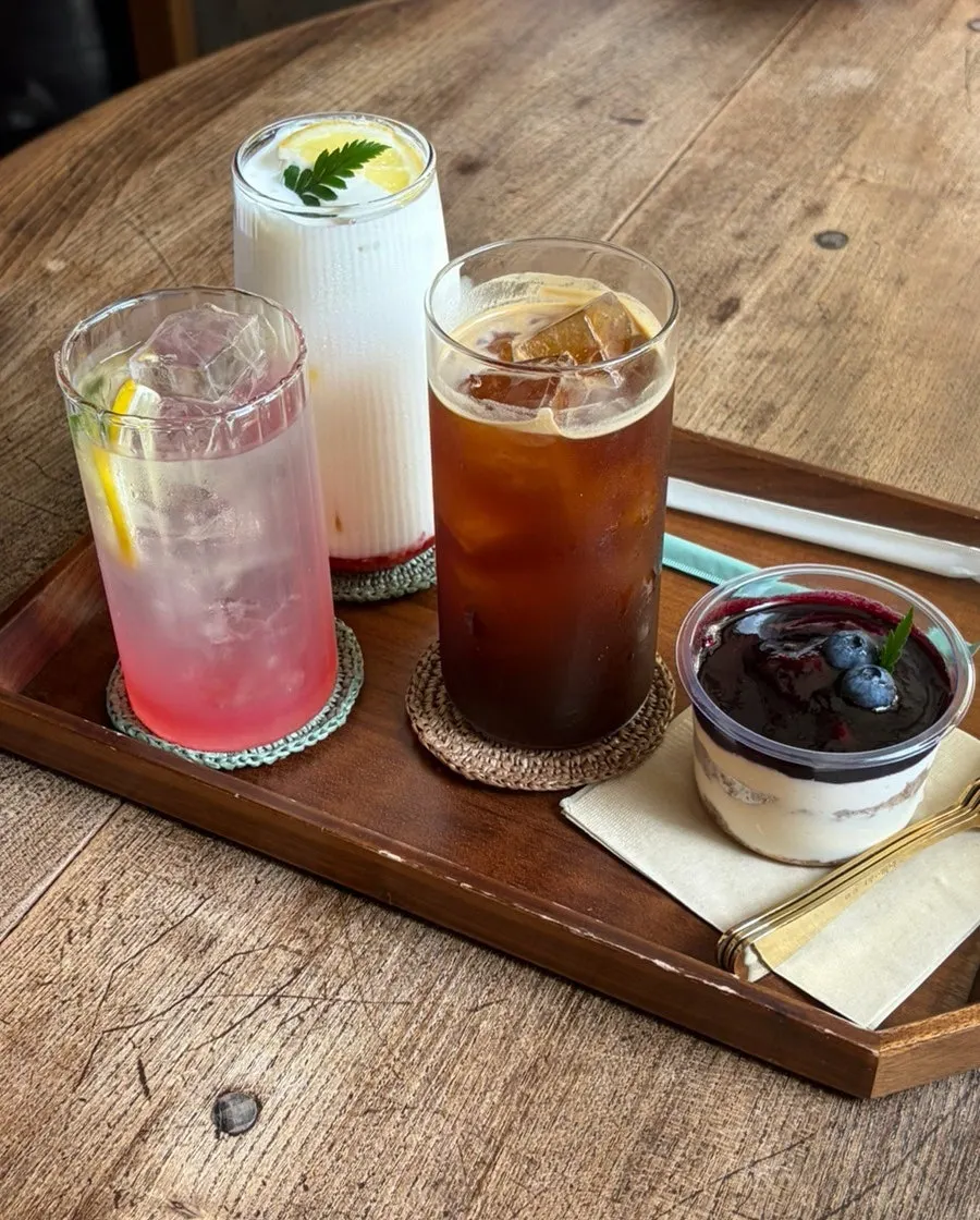 Three drinks: americano, strawberry cream latte, and pink lemon tea