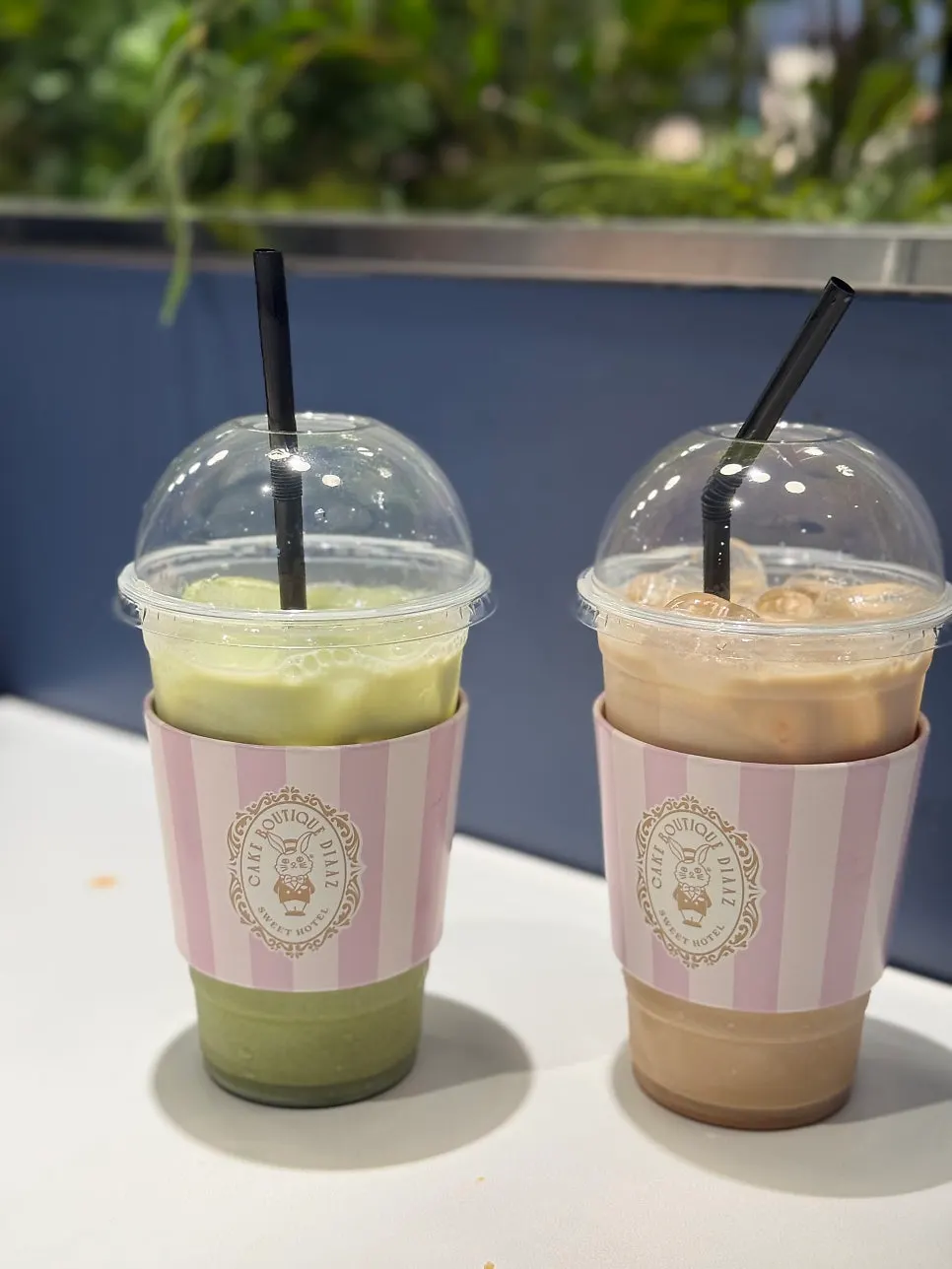 Earl Grey milk tea with a pink-striped cup sleeve
