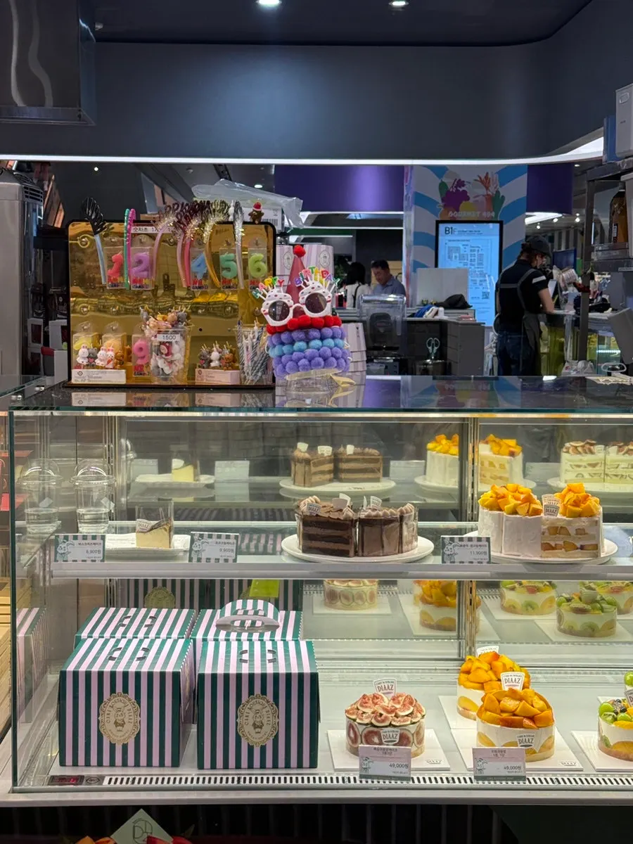 Cream cakes generously topped with fruit on display