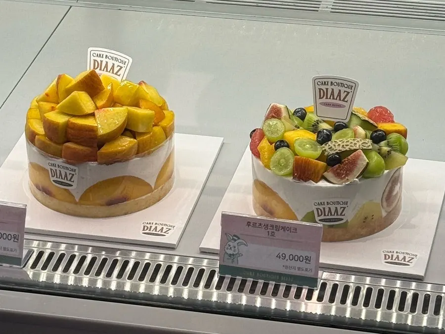 Fresh fruit whole cakes displayed at Café Diaz