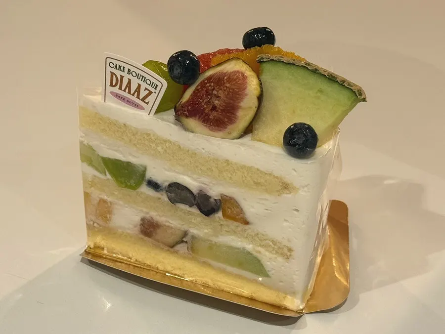 Fruit slice cake piled high with fresh fruit
