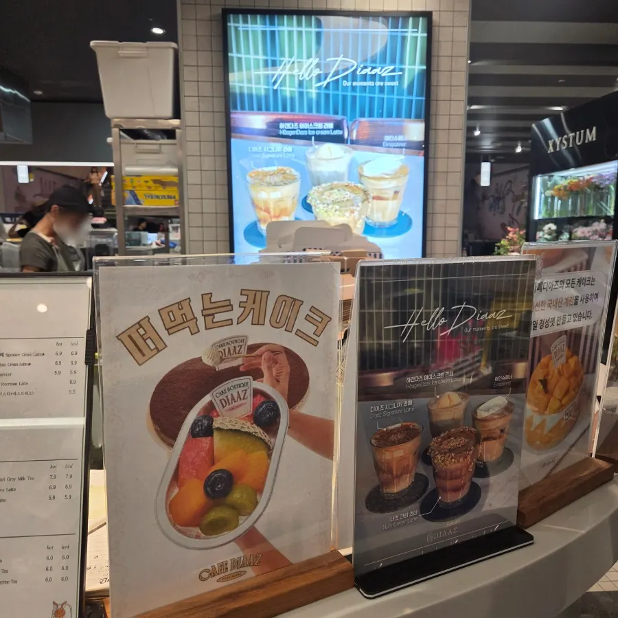 Display case of Café Diaz cakes made with seasonal fresh fruit