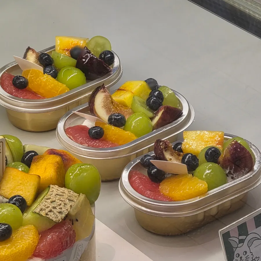 Spoonable fruit mini cake topped with various fruits