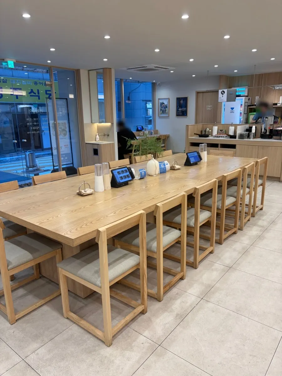 Wood-tone and white interior tables at Cafe Dongi