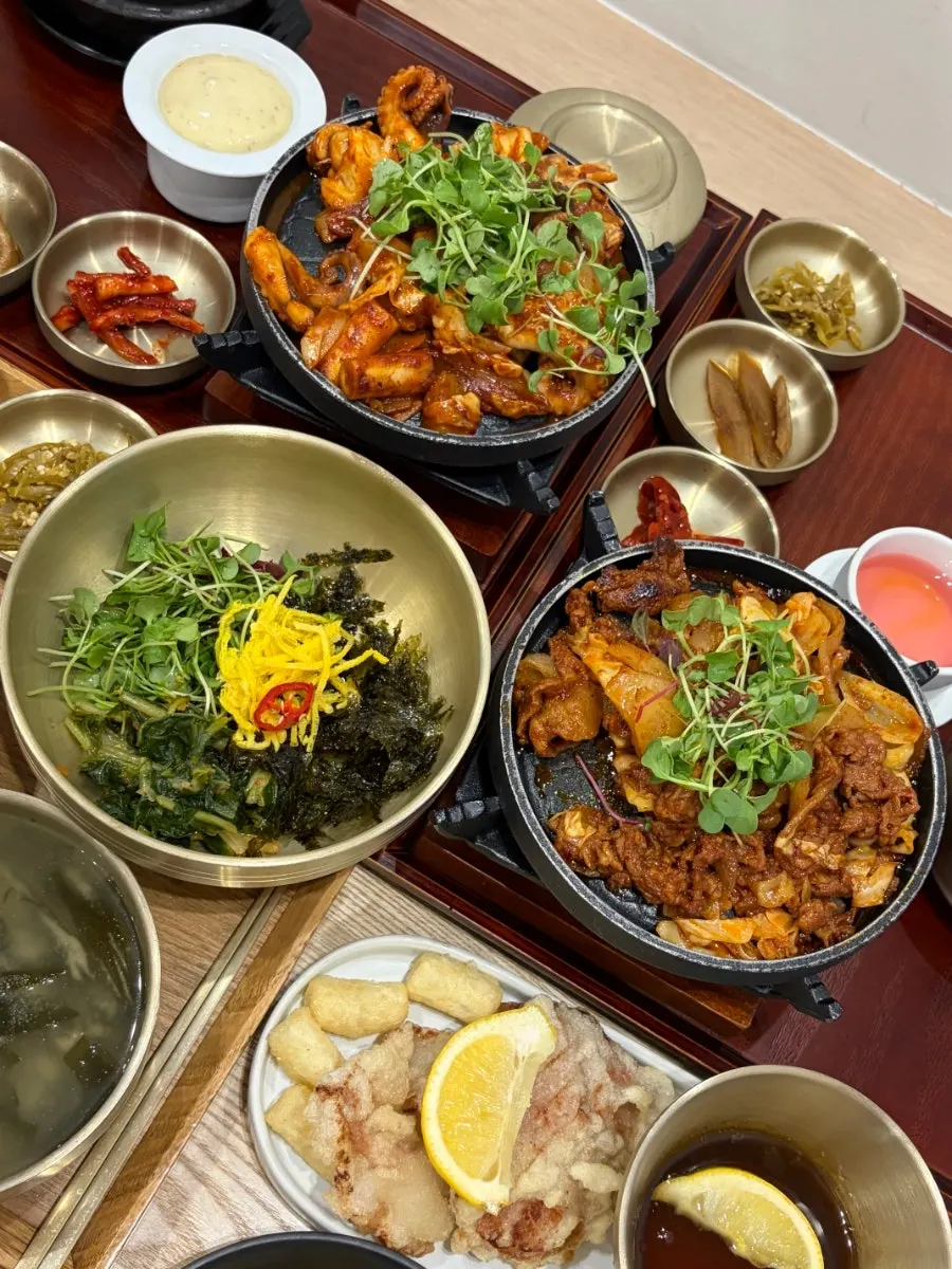 Table with jjukkumi, pork bulgogi, and tangsuyuk together