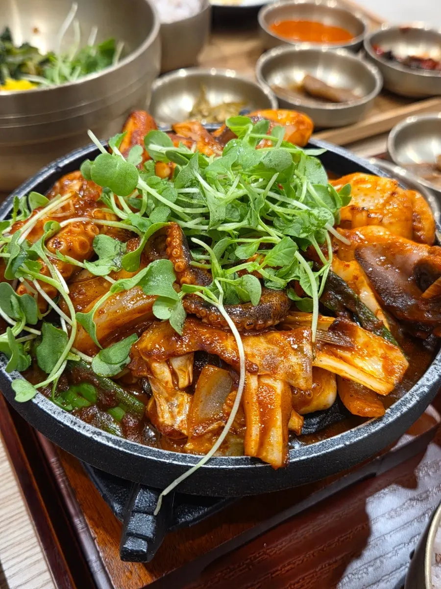 Plump grilled jjukkumi stir-fry over the brazier