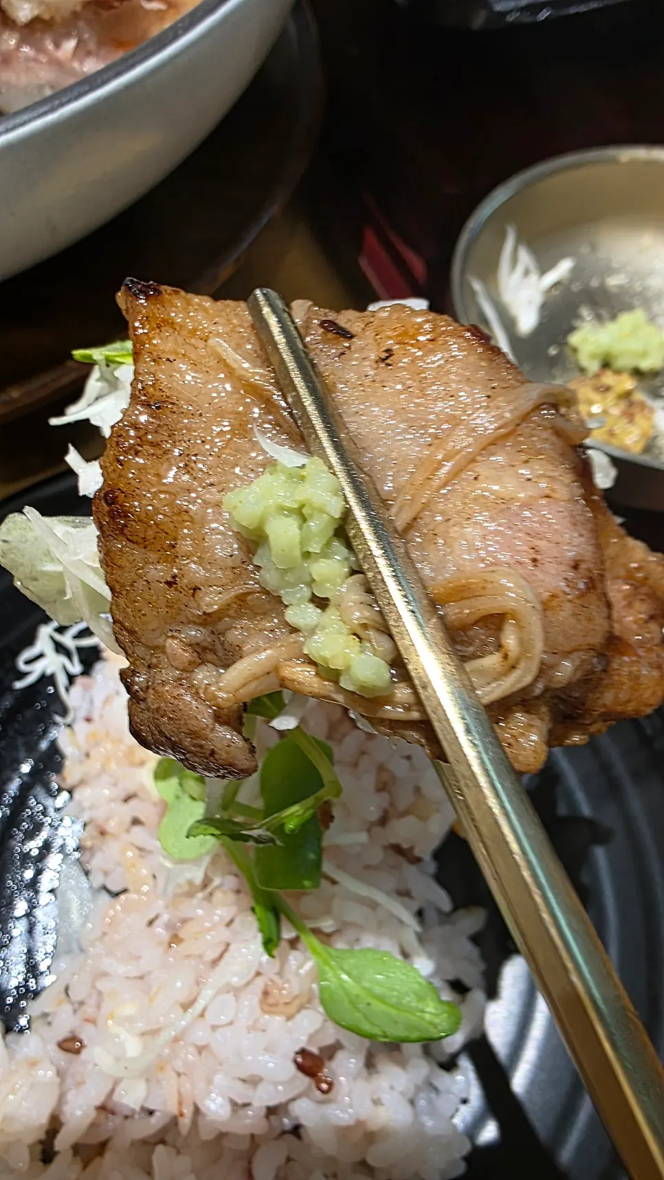 A piece of pork bulgogi wrapped in seaweed