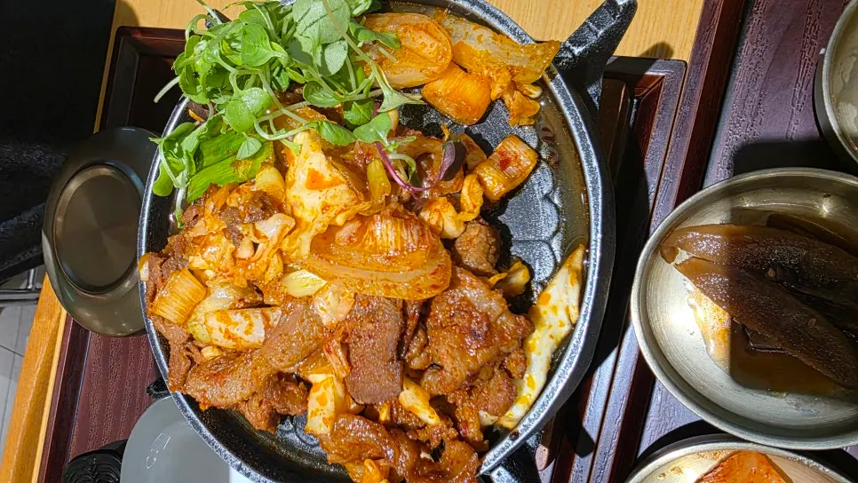 Full spread of the spicy grilled jeyuk hanjeongsik table