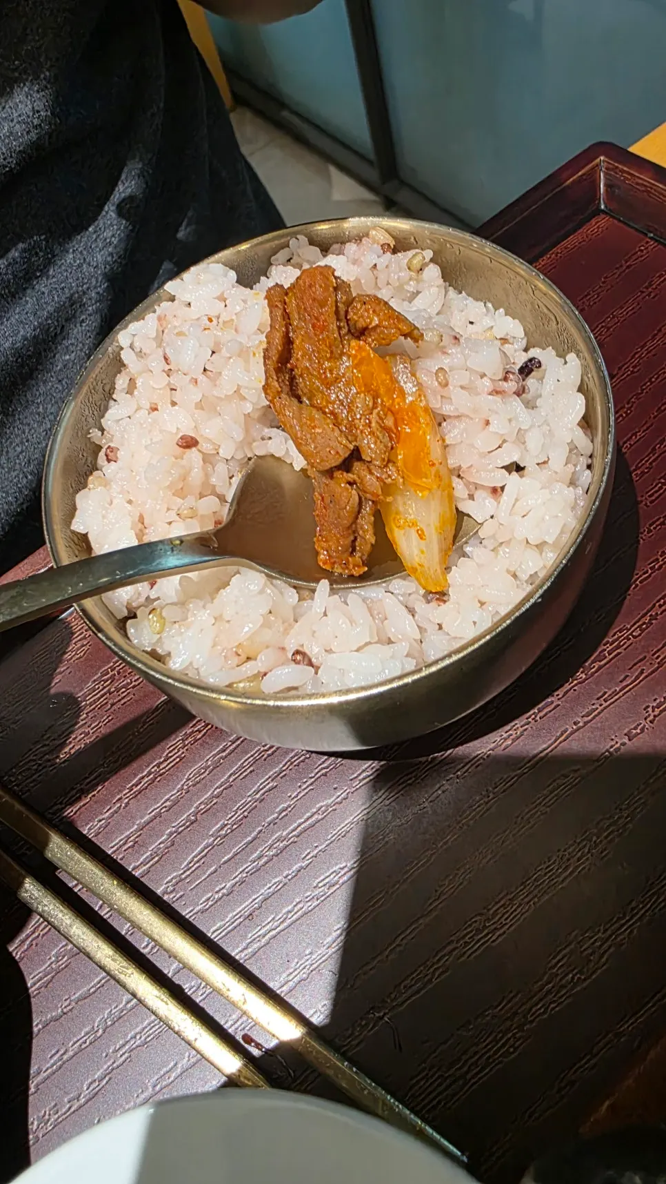 A piece of spicy jeyuk placed on rice