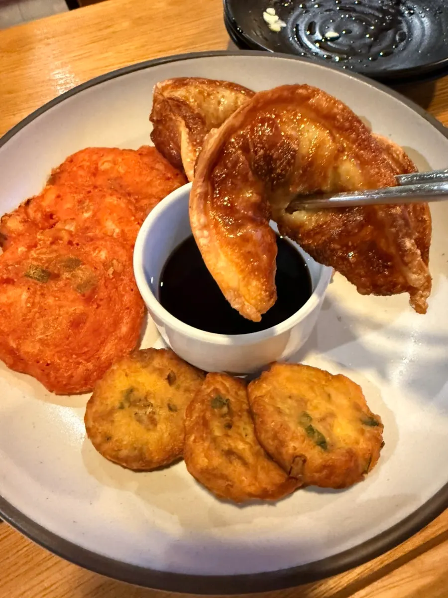 Close-up of a dumpling dipped in soy sauce