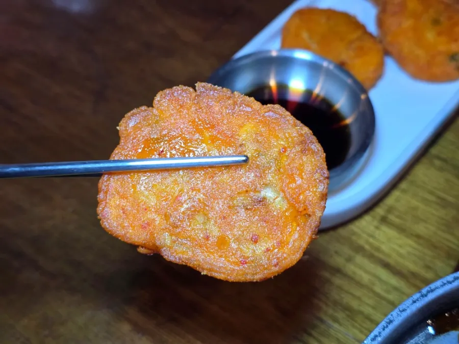 A piece of crispy kimchi pancake picked up