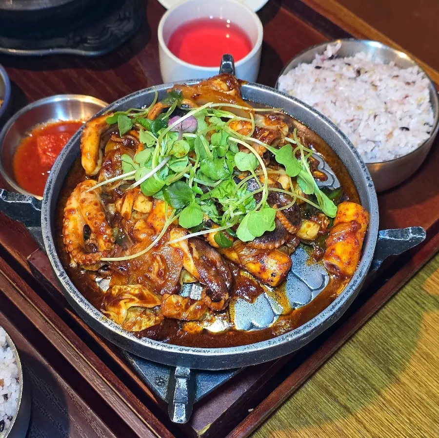 Stir-fried baby octopus served on a portable stove