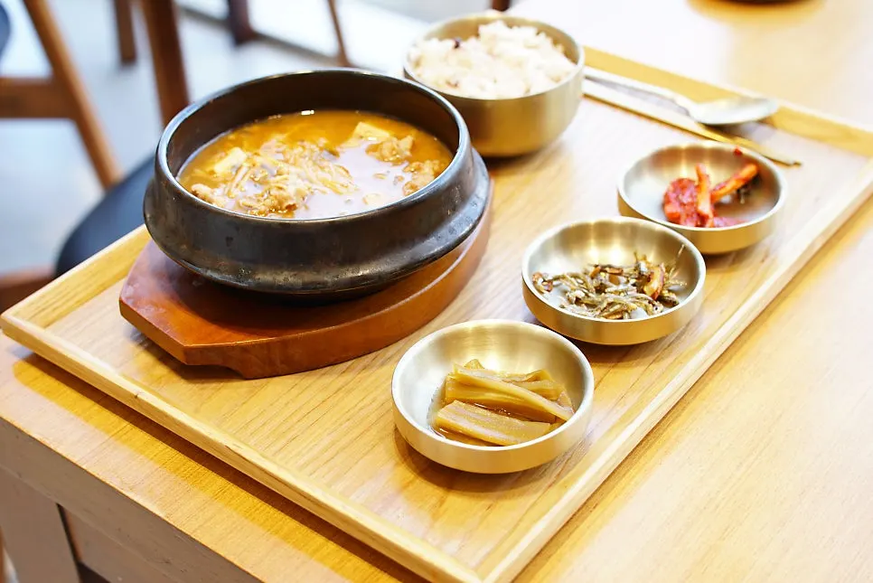 A full tray table setting served in brass bowls
