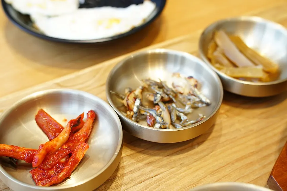 Three side dishes served in brass bowls