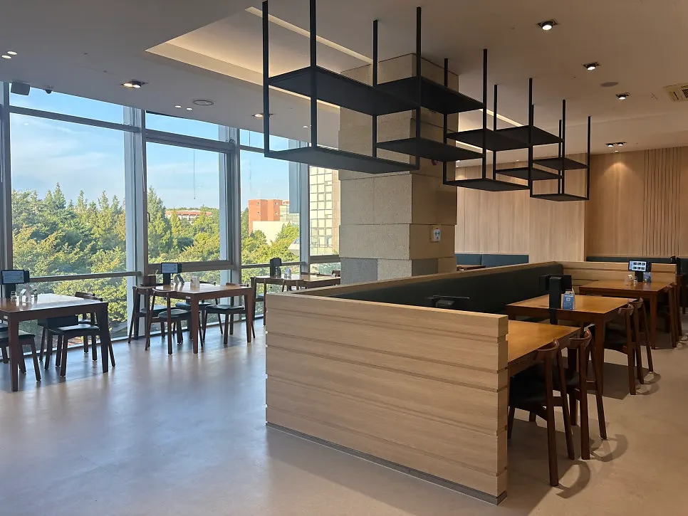 Spacious restaurant interior lit by large windows