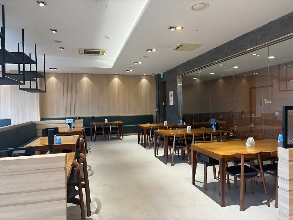 Wood-tone tables spaced generously apart