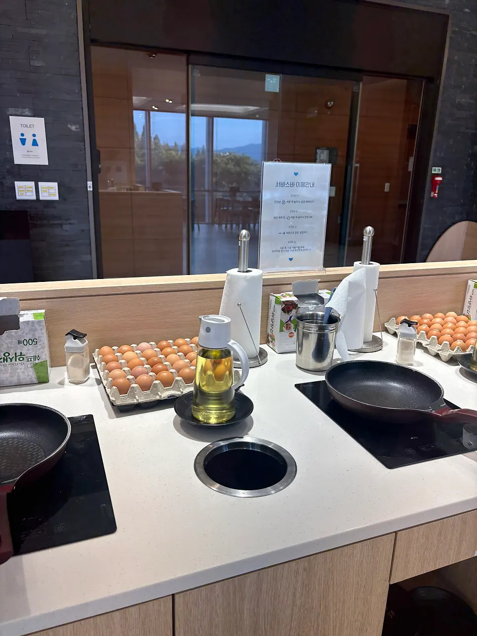Frying pans and eggs ready at the self-bar