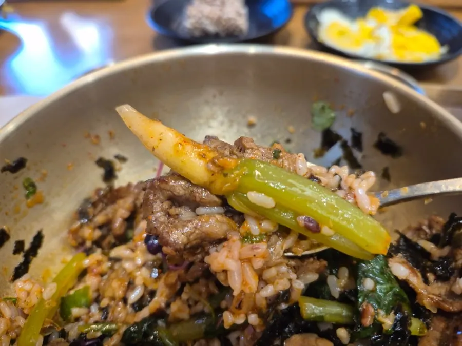 Table with yeolmu bibimbap and side dishes