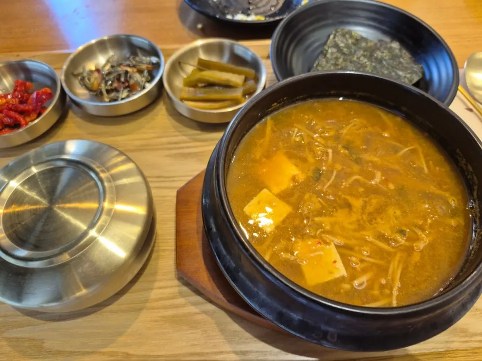 Tofu doenjang jjigae served with side dishes