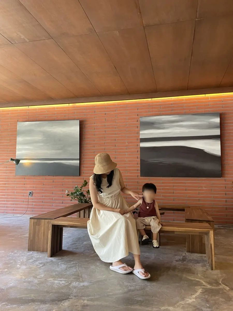 Table by the large window with trees and bamboo visible outside