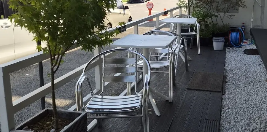 Outdoor terrace seats and bar tables at Caffeine Focus