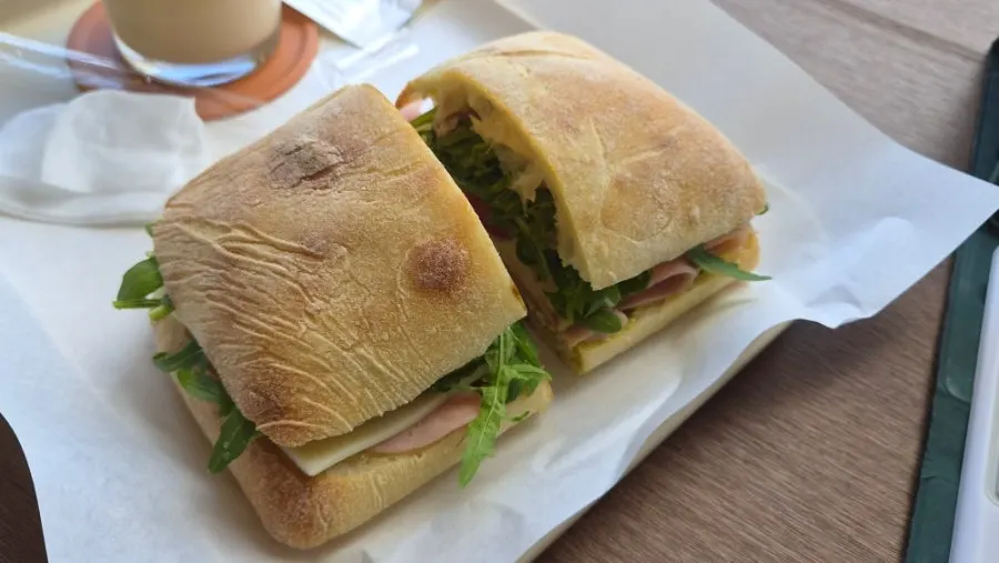 A plate with a freshly made ciabatta sandwich