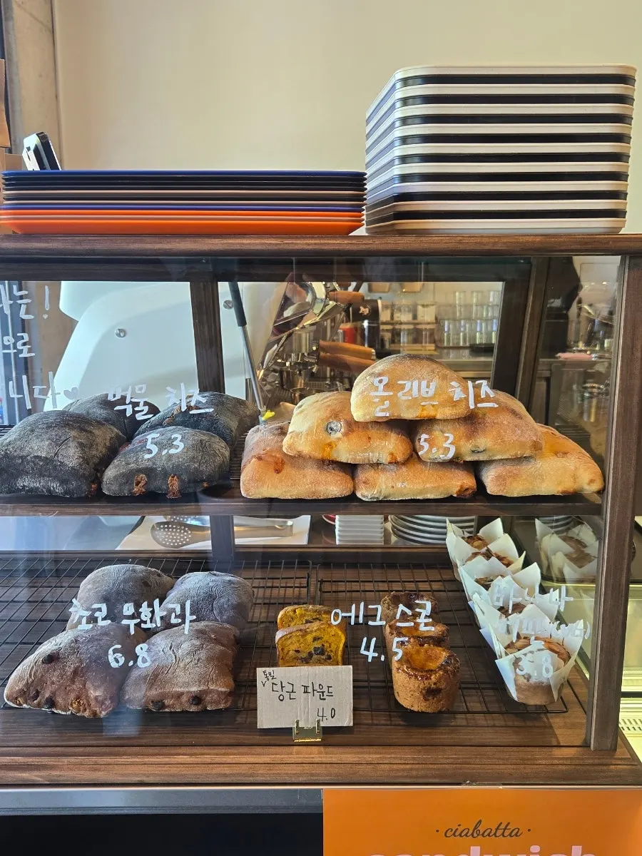 Olive cheese, squid ink cheese, and choco fig ciabatta on display