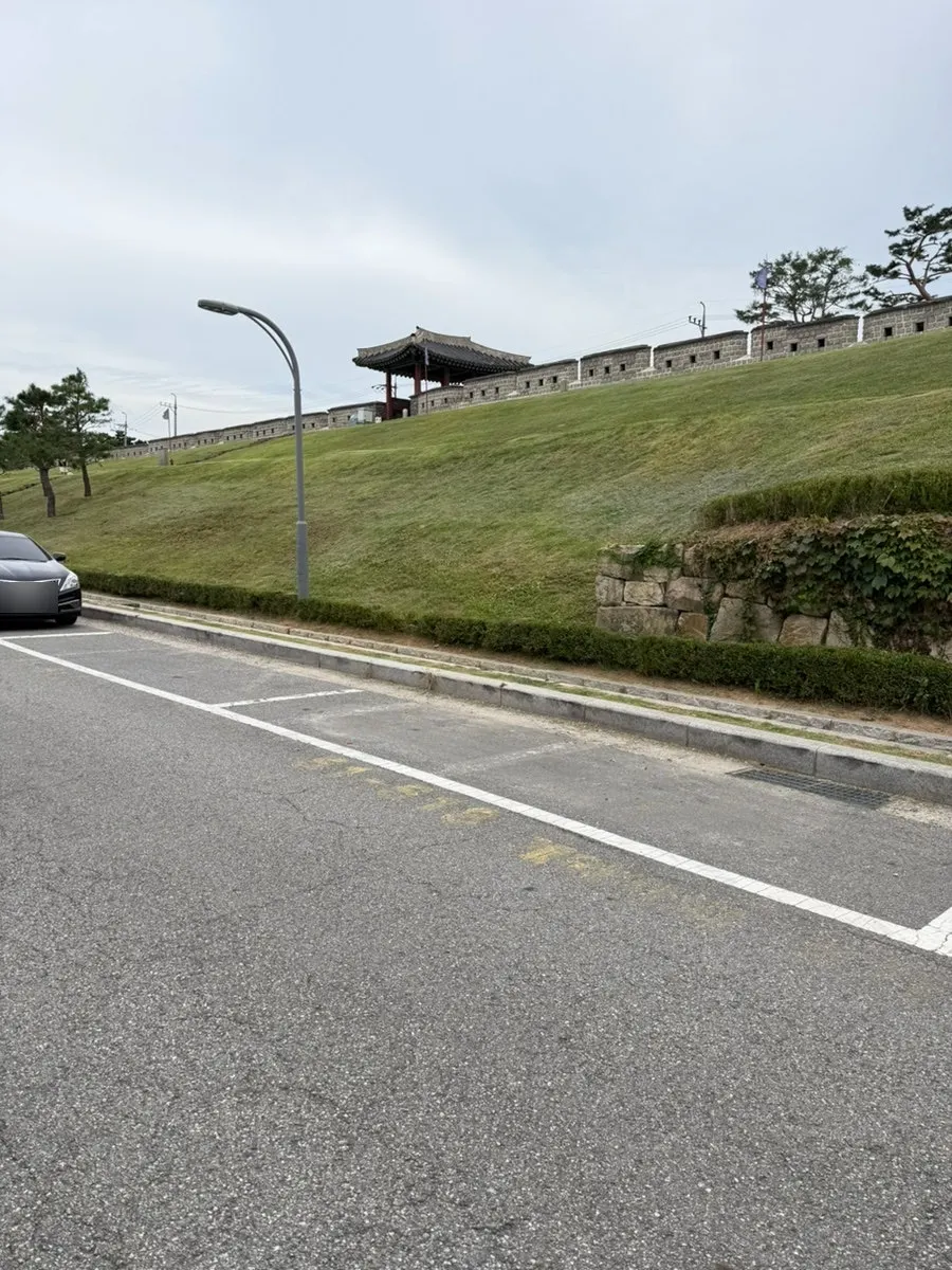 Full view of the Caffeine Focus building beside the fortress wall near Changnyongmun Gate